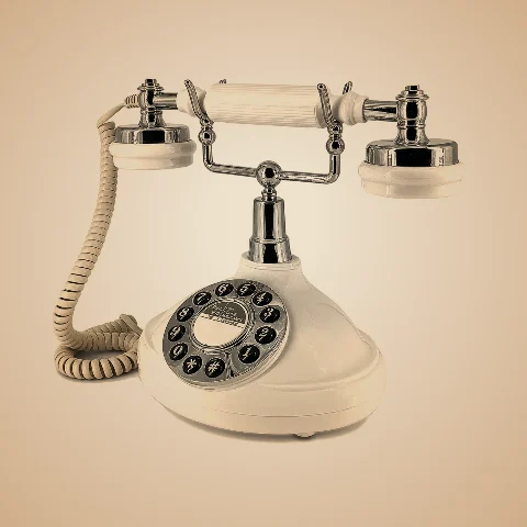 Telefone vintage branco com auscultador cromado, usado no Audioguestbook.
