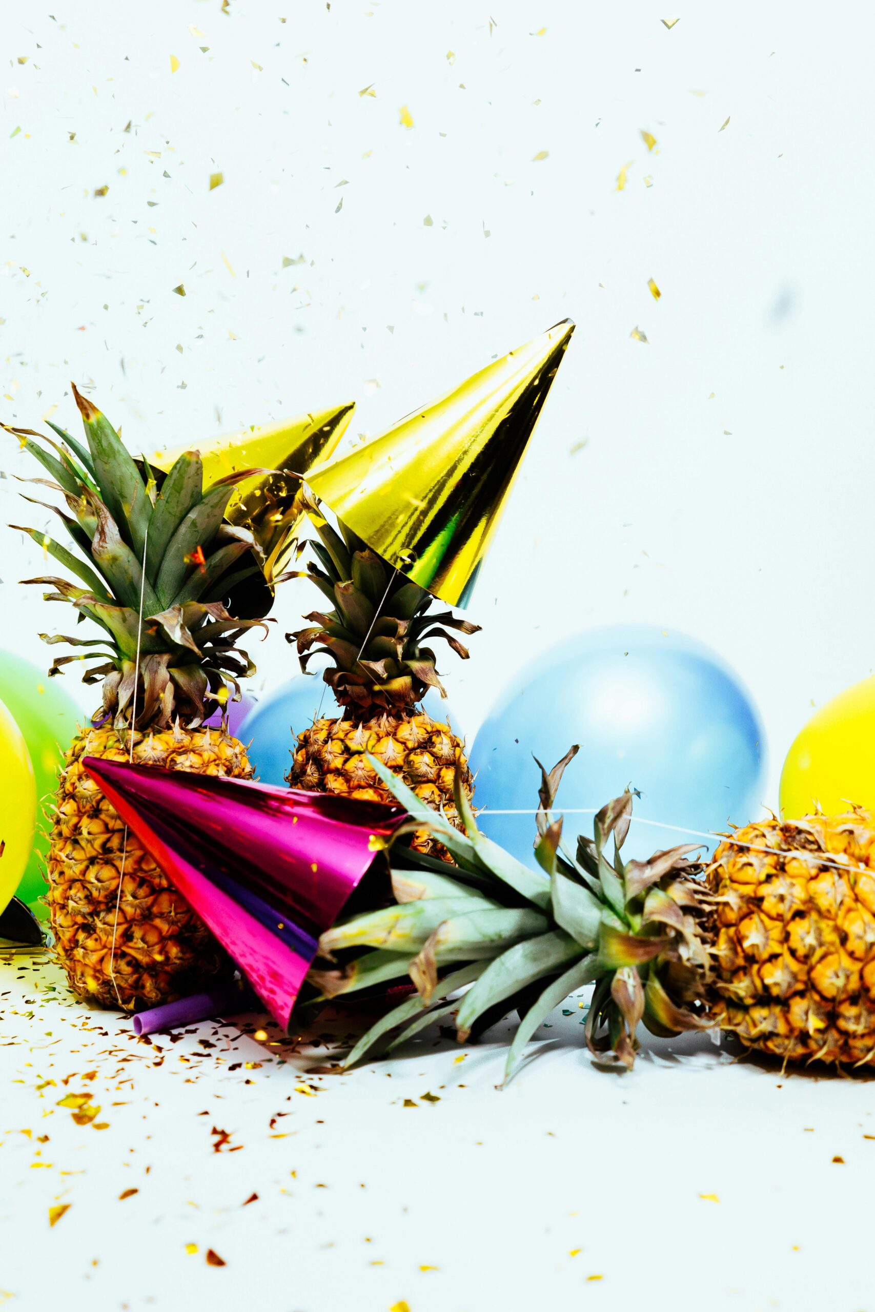 Vibrant party scene with pineapples, balloons, and confetti, perfect for celebration themes.
