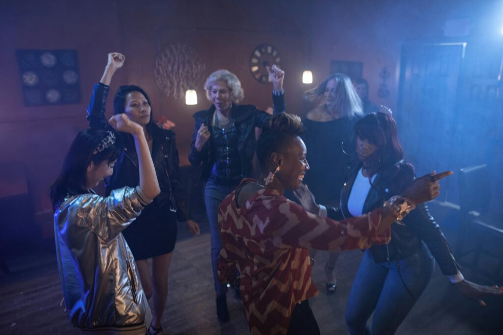Group of diverse women enjoying a night out dancing at a club.
